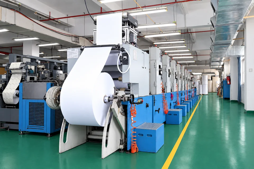 A white roll material passing through workshop equipment
